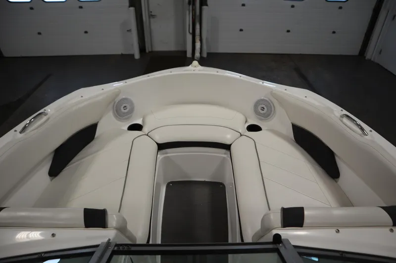 Slide: The Image of 2013 Yamaha Boats AR190 interior with white seating and speakers. - 11