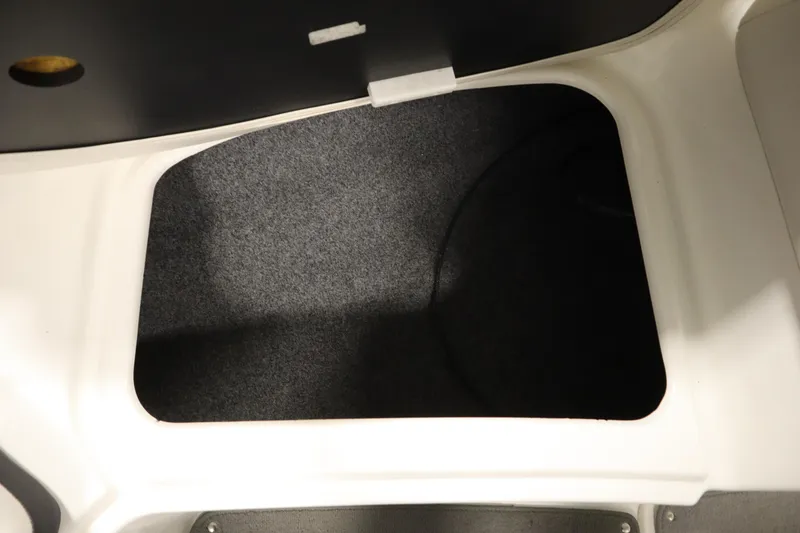 Slide: The Image of Storage compartment in 2013 Yamaha Boats AR190, featuring a carpeted interior. - 14
