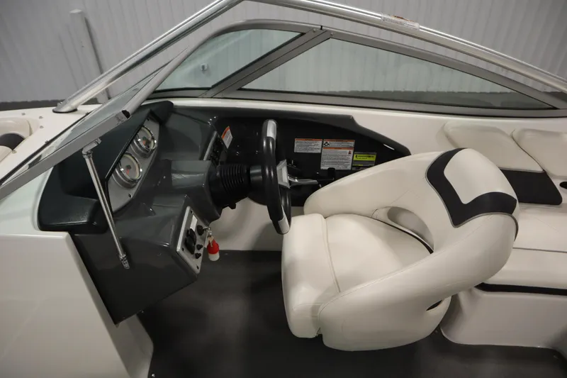 Slide: The Image of 2013 Yamaha Boats AR190 interior with steering wheel and white seating. - 15