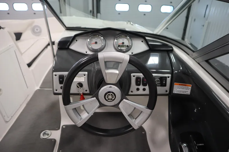 Slide: The Image of 2013 Yamaha Boats AR190 dashboard with steering wheel and control panel. - 16