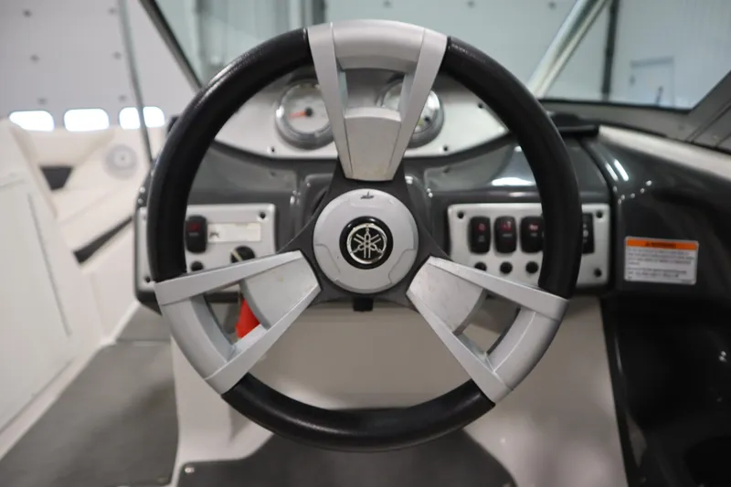 Slide: The Image of Steering wheel of a 2013 Yamaha Boats AR190, showcasing dashboard controls. - 17