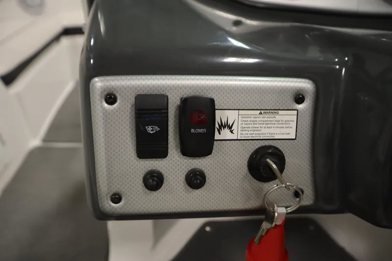 Slide: The Image of Control panel of a 2013 Yamaha Boats AR190 with switches and ignition key. - 19