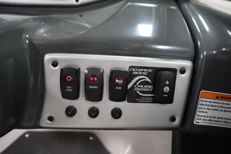 Slide: The Image of Control panel of 2013 Yamaha AR190 boat with various switches and warning label. - 20