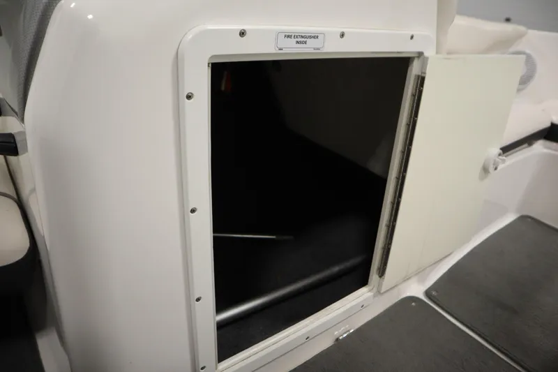 Slide: The Image of Open storage compartment on 2013 Yamaha AR190 boat, labeled for fire extinguisher. - 26