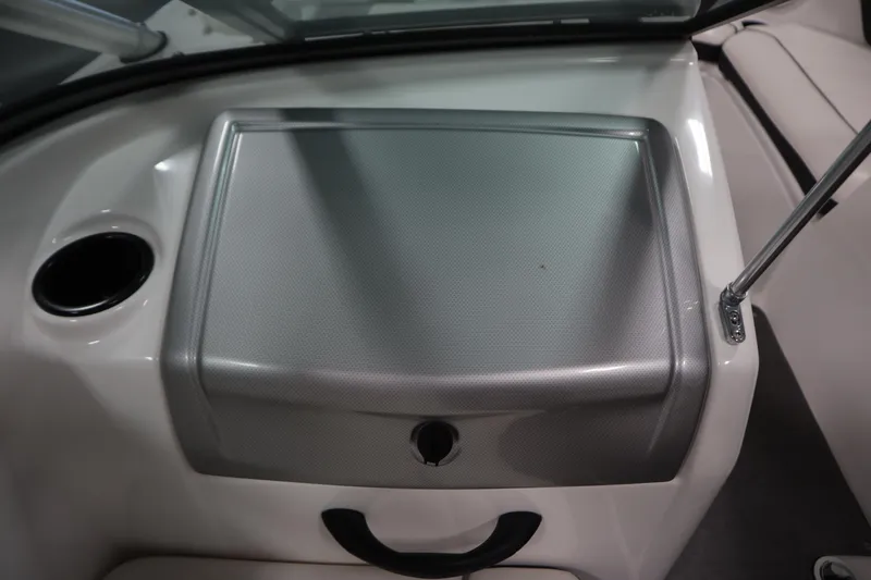 Slide: The Image of 2013 Yamaha AR190 boat interior with storage compartment and cup holder. - 27