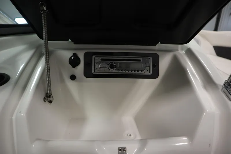 Slide: The Image of 2013 Yamaha AR190 boat dashboard with stereo system and storage compartment. - 28