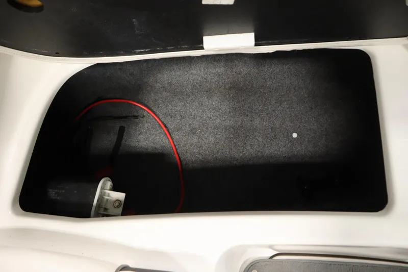 Slide: The Image of Storage compartment of a 2013 Yamaha Boats AR190 with visible wiring and components. - 32