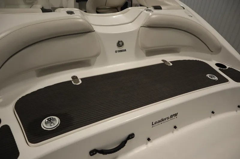 Slide: The Image of 2013 Yamaha Boats AR190 interior with cushioned seating and storage area. - 36