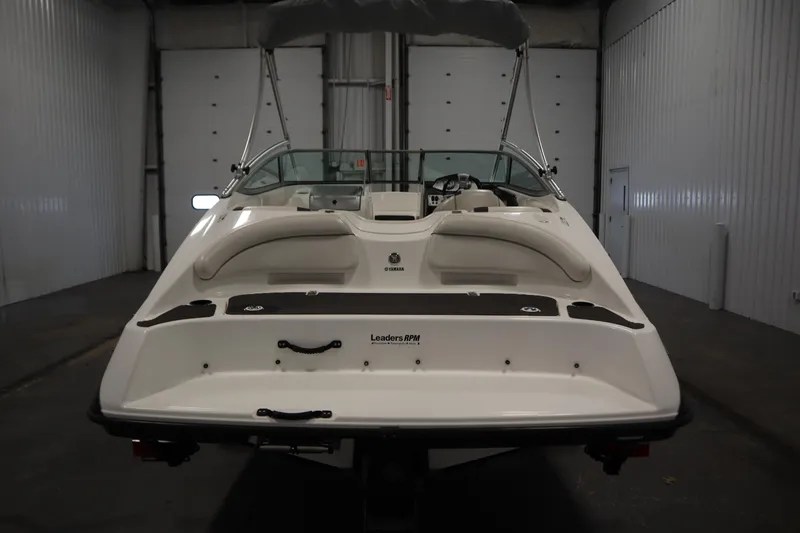 Slide: The Image of 2013 Yamaha Boats AR190 in a warehouse, rear view with seating and canopy. - 6