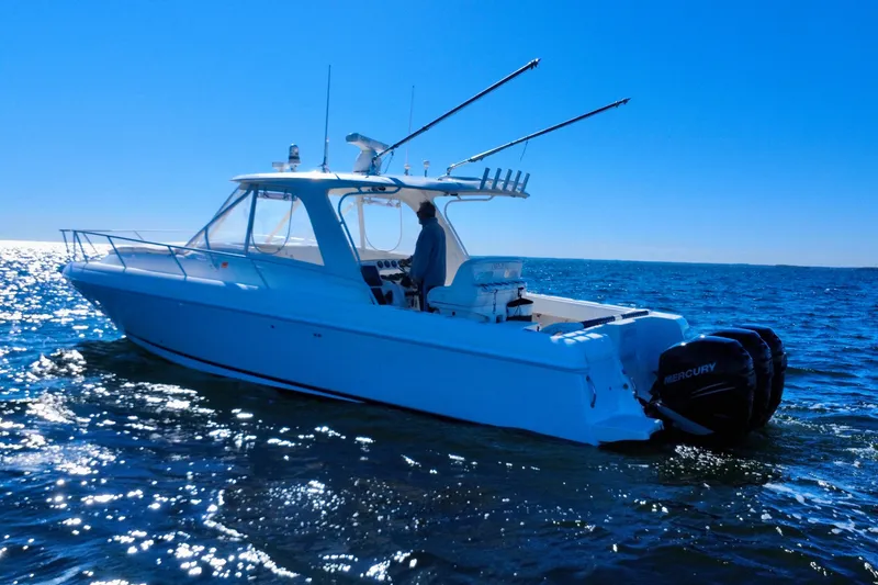 Slide: The Image of 2000 Intrepid 377 Walkaround boat cruising on open water. - 10