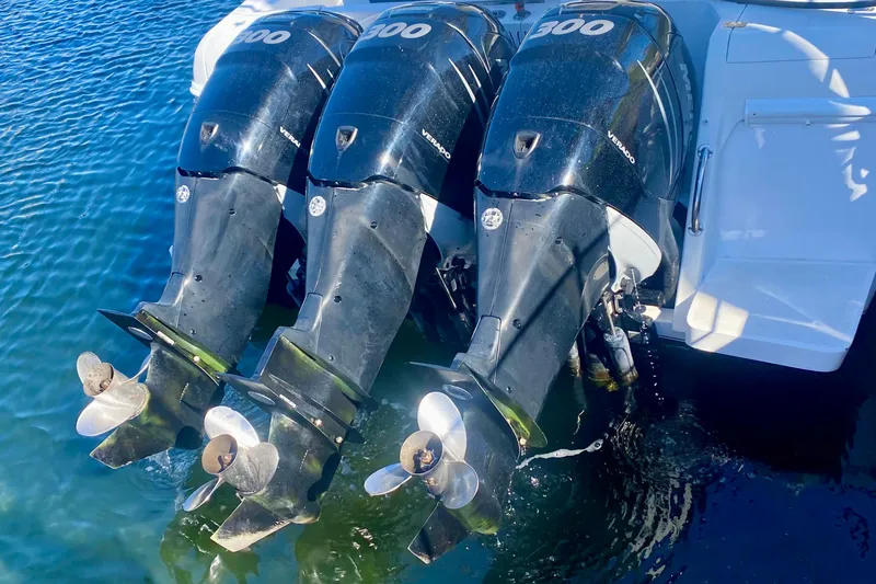 Slide: The Image of 2000 Intrepid 377 Walkaround boat cruising on open water with triple engines. - 15