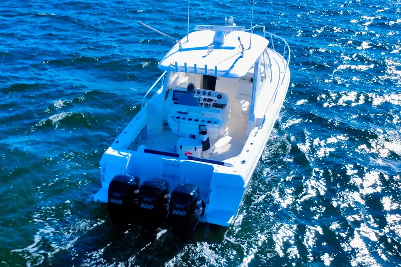 Slide: The Image of 2000 Intrepid 377 Walkaround boat cruising on open water under clear blue sky. - 16