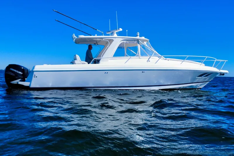 Slide: The Image of 2000 Intrepid 377 Walkaround boat cruising on blue ocean waters. - 20