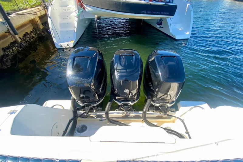 Slide: The Image of Triple outboard engines on a 2000 Intrepid 377 Walkaround boat in Miami marina. - 23