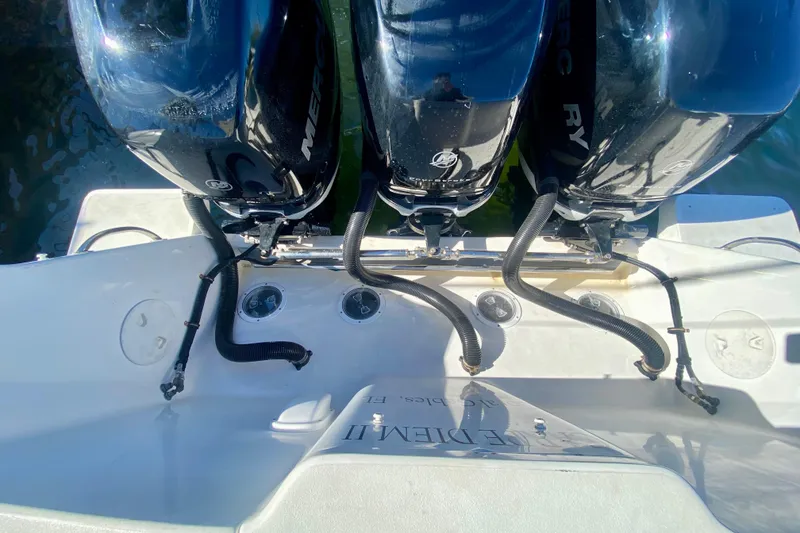 Slide: The Image of 2000 Intrepid 377 Walkaround boat interior with blue seating and twin Mercury engines. - 26