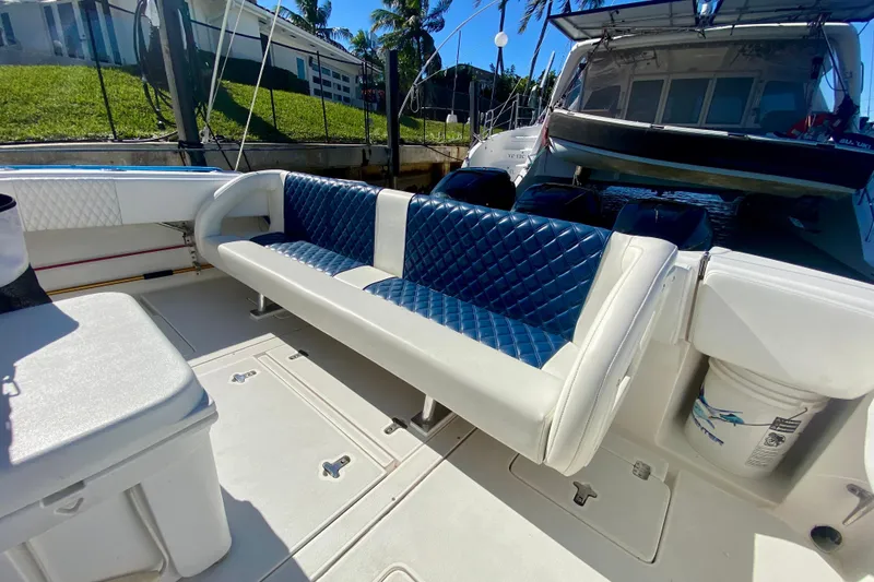 Slide: The Image of 2000 Intrepid 377 Walkaround boat interior with blue seating and white canopy. - 28