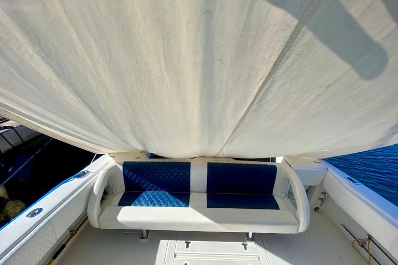 Slide: The Image of 2000 Intrepid 377 Walkaround boat with rod holders, under clear blue sky. - 29