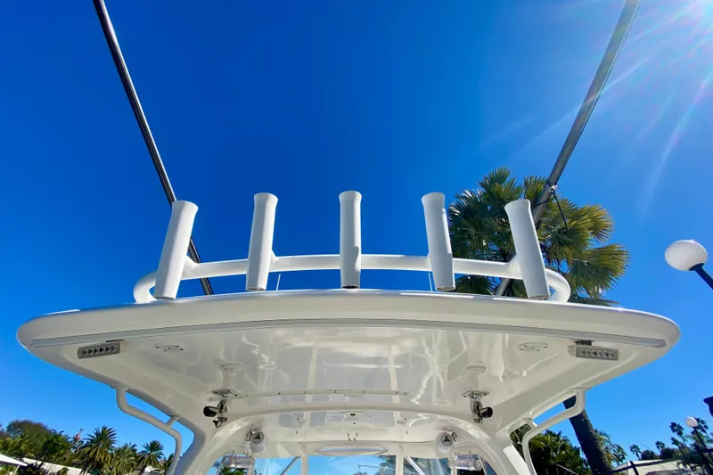 Slide: The Image of 2000 Intrepid 377 Walkaround boat interior with blue and white seating, docked by the water. - 30
