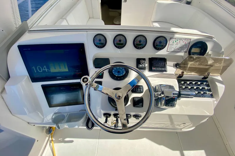 Slide: The Image of Control panel of a 2000 Intrepid 377 Walkaround boat with navigation screens and gauges. - 33