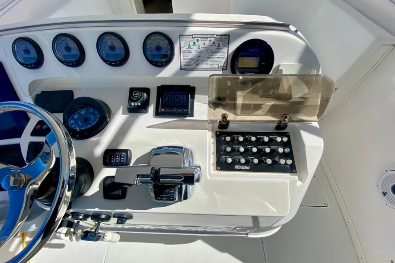 Slide: The Image of Dashboard of a 2000 Intrepid 377 Walkaround boat with three RPM gauges. - 36