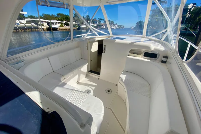 Slide: The Image of 2000 Intrepid 377 Walkaround boat interior with white seating and waterfront view. - 39