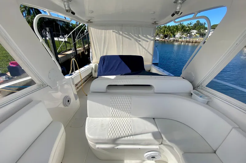 Slide: The Image of Interior view of a 2000 Intrepid 377 Walkaround boat with white seating and clear windows. - 40