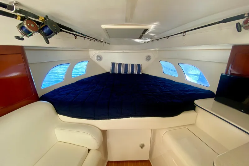 Slide: The Image of Cozy cabin interior of 2000 Intrepid 377 Walkaround with blue bedding and windows. - 51