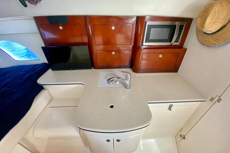 Slide: The Image of Interior of 2000 Intrepid 377 Walkaround with kitchenette, microwave, and cozy sleeping area. - 53