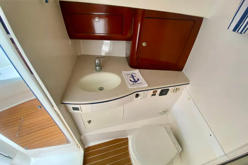 Slide: The Image of Shower area in 2000 Intrepid 377 Walkaround boat with wooden floor and glass door. - 58