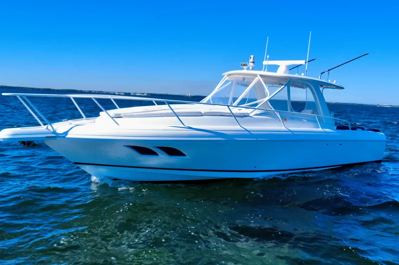 Slide: The Image of 2000 Intrepid 377 Walkaround boat on open water under clear blue sky. - 6