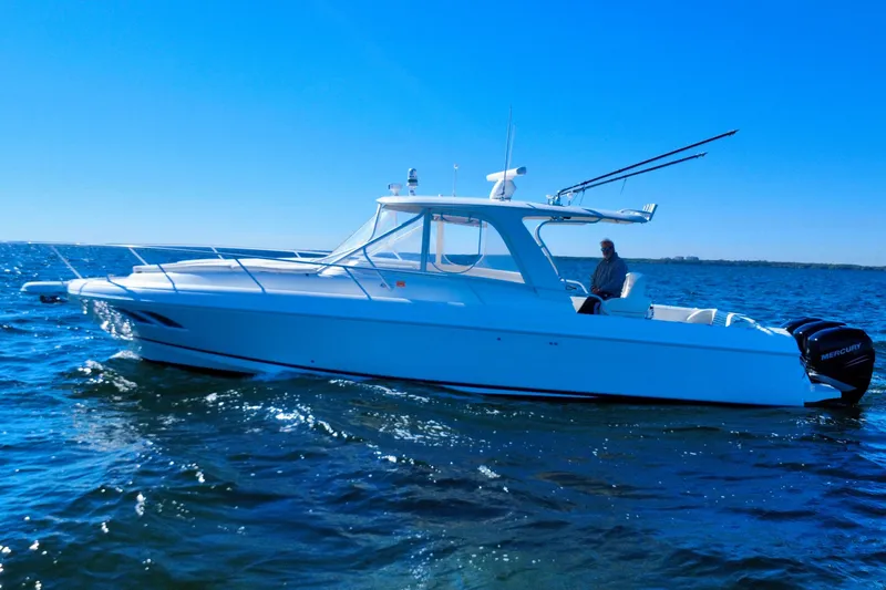 Slide: The Image of 2000 Intrepid 377 Walkaround boat on open water, featuring dual Mercury engines. - 9