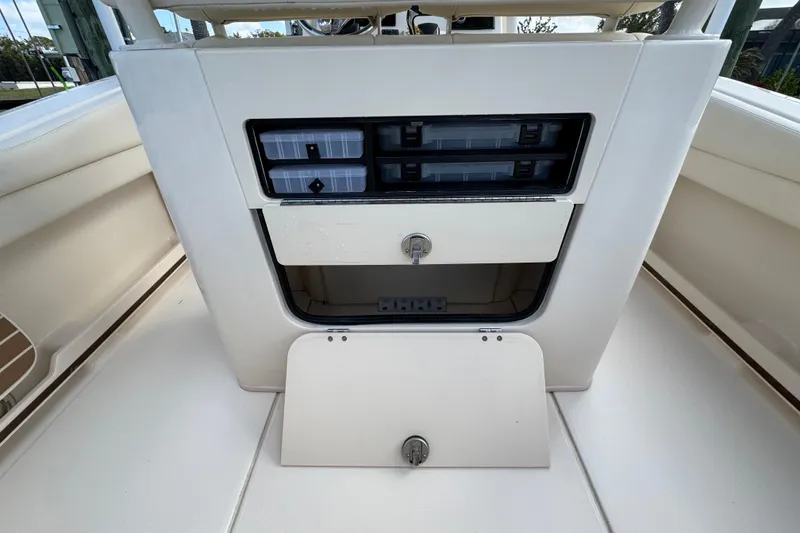 Slide: The Image of 2023 Grady-White Fisherman 236 boat storage compartments with secure latches and organized space. - 19