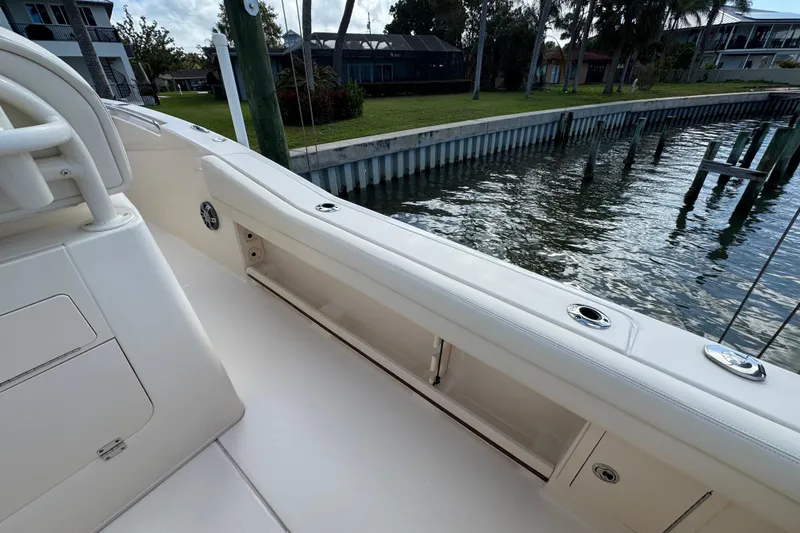 Slide: The Image of 2023 Grady-White Fisherman 236 boat interior, docked by waterfront homes. - 21
