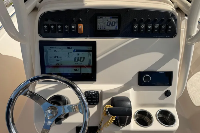 Slide: The Image of 2023 Grady-White Fisherman 236 dashboard with steering wheel and electronic displays. - 26