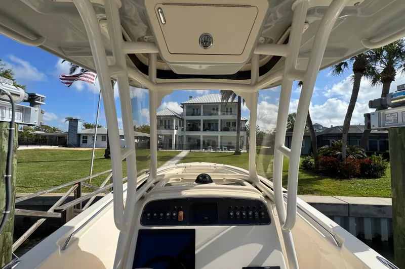 Slide: The Image of 2023 Grady-White Fisherman 236 boat docked, view from helm, American flag visible. - 27