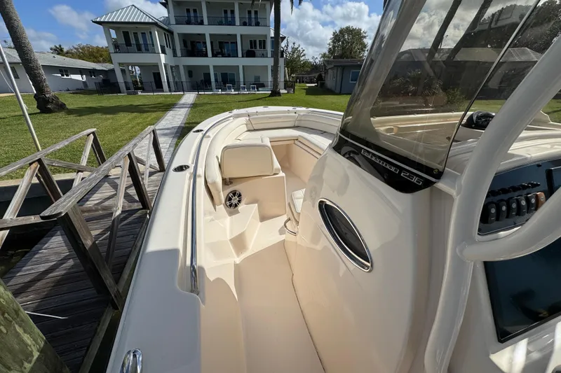 Slide: The Image of 2023 Grady-White Fisherman 236 boat docked near a modern waterfront home. - 28