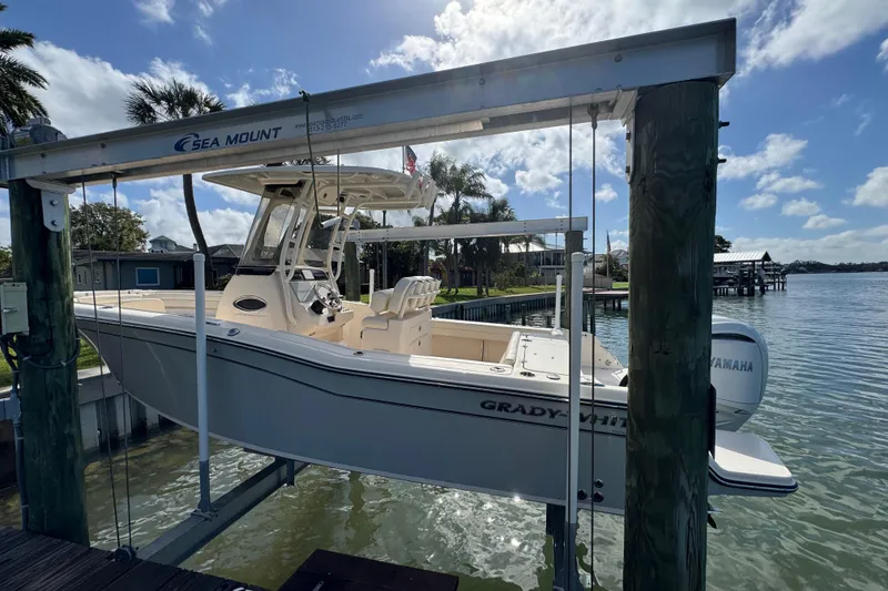 Slide: The Image of 2023 Grady-White Fisherman 236 boat on lift by waterfront, sunny day. - 3