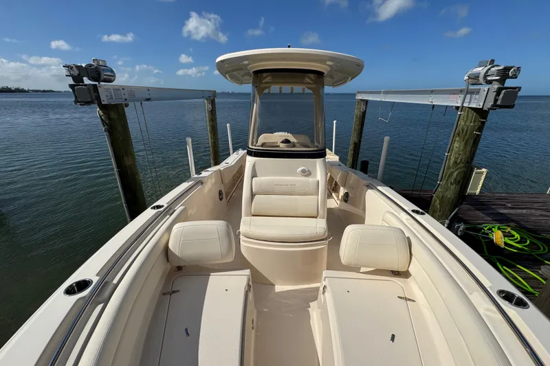Slide: The Image of 2023 Grady-White Fisherman 236 boat docked by the water under a clear blue sky. - 35