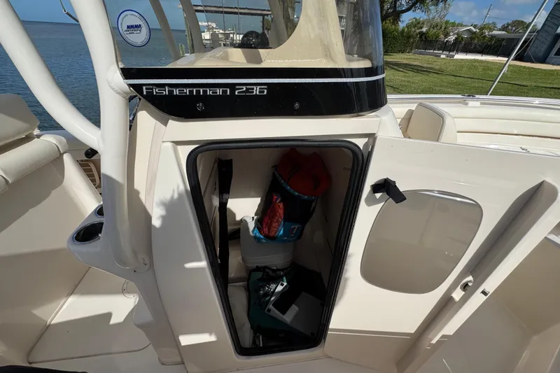 Slide: The Image of 2023 Grady-White Fisherman 236 boat interior storage compartment with open door. - 38