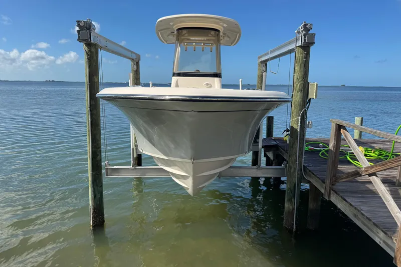 Slide: The Image of 2023 Grady-White Fisherman 236 boat on lift by dock, clear blue sky. - 4