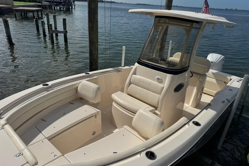 Slide: The Image of 2023 Grady-White Fisherman 236 boat docked by the water, showcasing seating and helm. - 6
