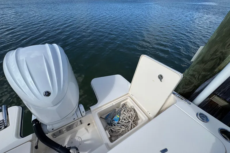 Slide: The Image of 2023 Grady-White Fisherman 236 boat with open storage compartment and outboard motor. - 9