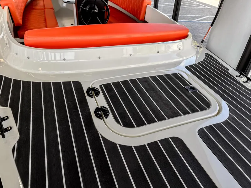 Slide: The Image of 2024 Vision Marine Fantail 217 boat interior with orange seating and striped flooring. - 2