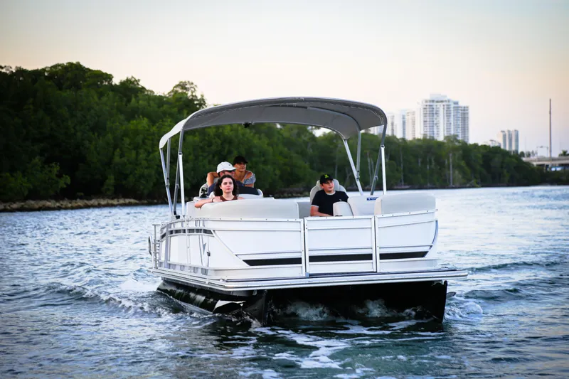 Slide: The Image of 2025 Vision Marine Technologies V24 boat cruising on a scenic waterway with passengers. - 11