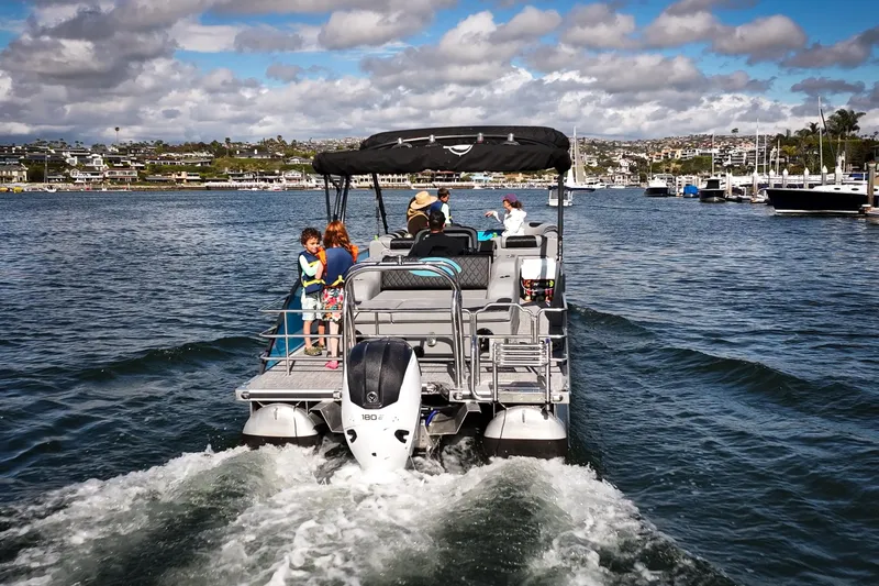 Slide: The Image of 2025 Vision Marine Technologies V30 boat cruising on a sunny day with passengers onboard. - 4