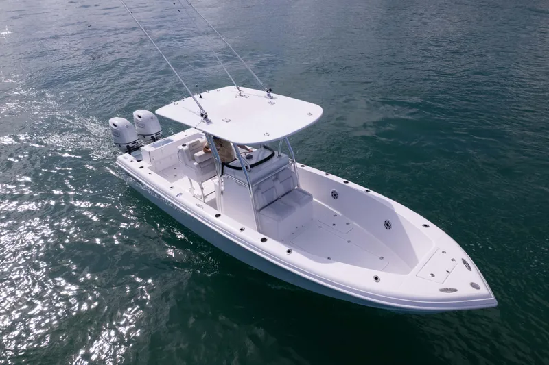 Slide: The Image of 2024 Bluewater 2550 boat cruising on open water, featuring dual engines and a sleek design. - 11