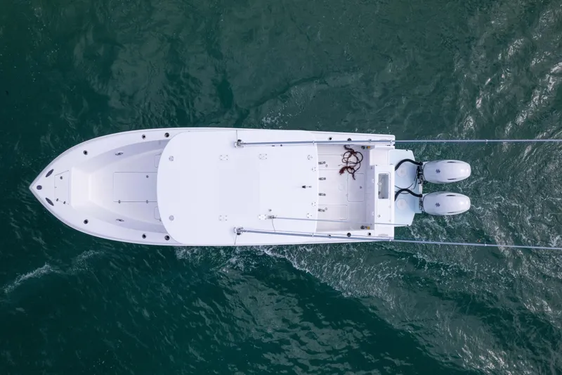 Slide: The Image of Overhead view of 2024 Bluewater 2550 boat on water with dual engines. - 15