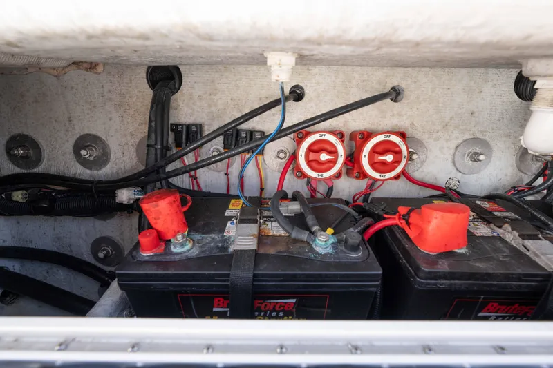Slide: The Image of Battery compartment of 2024 Bluewater 2550 boat with wiring and switches. - 17