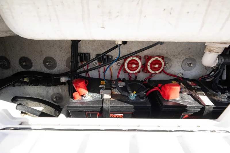Slide: The Image of Battery compartment of 2024 Bluewater 2550 boat with wiring and switches. - 19