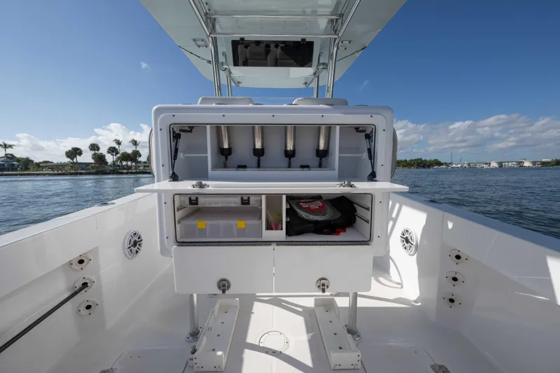 Slide: The Image of 2024 Bluewater 2550 boat with open storage compartments on a sunny day. - 22